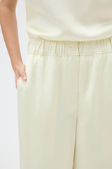 Profile view of model wearing the Oroton Double Satin Pyjama Pant in Champagne and 100% viscose fabric for Women .