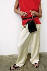 Profile view of model wearing the Oroton Double Satin Pyjama Pant in Champagne and 100% viscose fabric for Women .
