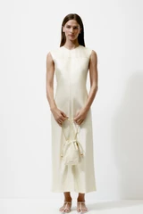 Profile view of model wearing the Oroton Double Satin Sheath Dress in Champagne and 100% viscose fabric for Women .