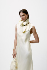 Profile view of model wearing the Oroton Double Satin Sheath Dress in Champagne and 100% viscose fabric for Women .