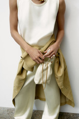 Profile view of model wearing the Oroton Double Satin Tank in Champagne and 100% viscose fabric for Women .
