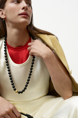 Profile view of model wearing the Oroton Double Satin Tank in Champagne and 100% viscose fabric for Women .