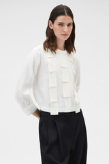 Profile view of model wearing the Oroton Folded Ribbon Top in Antique White and 100% linen fabric for Women .
