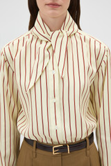 Profile view of model wearing the Oroton Stripe Tie Neck Shirt in Lemon/Rich Red and 100% silk habotai fabric for Women .