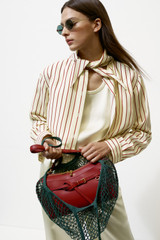 Profile view of model wearing the Oroton Stripe Tie Neck Shirt in Lemon/Rich Red and 100% silk habotai fabric for Women .