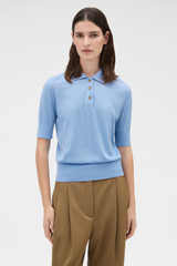 Profile view of model wearing the Oroton Knit Polo Top in Porcelain Blue and 90% merino wool and 10% silk blend fabric for Women .