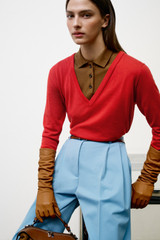 Profile view of model wearing the Oroton Knit Polo Top in Dark Rye and 90% merino wool and 10% silk blend fabric for Women .