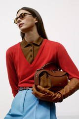 Profile view of model wearing the Oroton Knit Polo Top in Dark Rye and 90% merino wool and 10% silk blend fabric for Women .