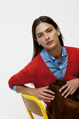 Profile view of model wearing the Oroton Deep V Knit in Poppy and 90% merino wool and 10% silk blend fabric for Women .