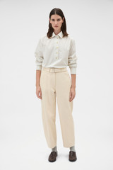 Profile view of model wearing the Oroton Washed Twill Barrel Leg Pant in Coconut and 100% cotton fabric for Women .
