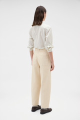 Profile view of model wearing the Oroton Washed Twill Barrel Leg Pant in Coconut and 100% cotton fabric for Women .