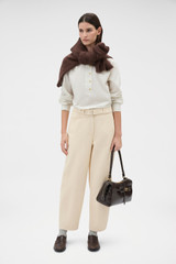 Profile view of model wearing the Oroton Washed Twill Barrel Leg Pant in Coconut and 100% cotton fabric for Women .