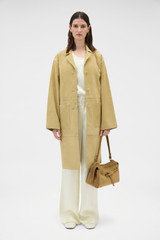Profile view of model wearing the Oroton Suede Coat in Sepia and 100% suede leather for Women .