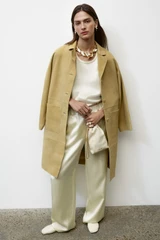 Profile view of model wearing the Oroton Suede Coat in Sepia and 100% suede leather for Women .