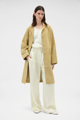 Profile view of model wearing the Oroton Suede Coat in Sepia and 100% suede leather for Women .