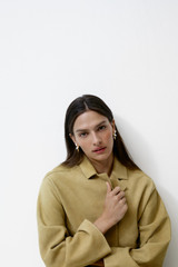 Profile view of model wearing the Oroton Suede Coat in Sepia and 100% suede leather for Women .