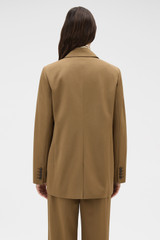 Profile view of model wearing the Oroton Single Breasted Blazer in Dark Rye and 100% wool fabric for Women .