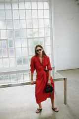 Profile view of model wearing the Oroton Silk Sarong Dress in Poppy and 100% silk twill fabric for Women .
