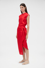 Profile view of model wearing the Oroton Silk Sarong Skirt in Poppy and 100% silk twill fabric for Women .