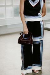 Profile view of model wearing the Oroton Silk Scarf Pyjama Pant in Black and 100% silk twill fabric for Women .