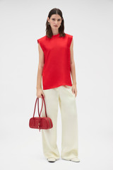 Profile view of model wearing the Oroton Silk Shell Top in Poppy and 100% silk twill fabric for Women .