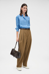 Profile view of model wearing the Oroton Tonal Stripe Silk Shirt in Porcelain Blue and 100% silk twill fabric for Women .