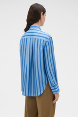 Profile view of model wearing the Oroton Tonal Stripe Silk Shirt in Porcelain Blue and 100% silk twill fabric for Women .