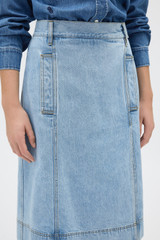 Profile view of model wearing the Oroton Button Detail Denim Skirt in Light Vintage Wash and 100% cotton fabric for Women .
