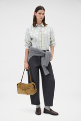 Profile view of model wearing the Oroton Washed Twill Barrel Leg Pant in Washed Black and 100% cotton fabric for Women .