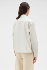Profile view of model wearing the Oroton Soft Check Button Shirt in Cream and 100% cotton fabric for Women .