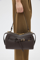 Profile view of model wearing the Oroton Cleo Smooth Shoulder Bag in Dark Chocolate and Premium smooth leather for Women .