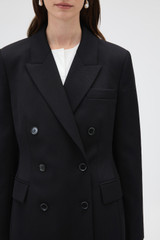 Profile view of model wearing the Oroton Shaped Double Breasted Blazer in Black and 100% wool fabric for Women .