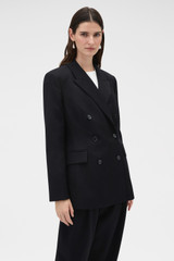 Profile view of model wearing the Oroton Shaped Double Breasted Blazer in Black and 100% wool fabric for Women .
