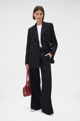 Profile view of model wearing the Oroton Shaped Double Breasted Blazer in Black and 100% wool fabric for Women .
