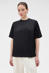 Profile view of model wearing the Oroton Double Satin Tee in Black and 100% viscose fabric for Women .