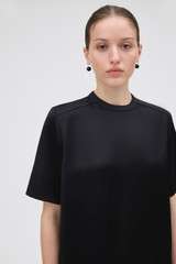 Profile view of model wearing the Oroton Double Satin Tee in Black and 100% viscose fabric for Women .