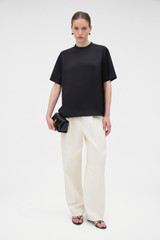 Profile view of model wearing the Oroton Double Satin Tee in Black and 100% viscose fabric for Women .