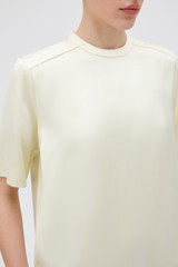 Profile view of model wearing the Oroton Double Satin Tee in Champagne and 100% viscose fabric for Women .
