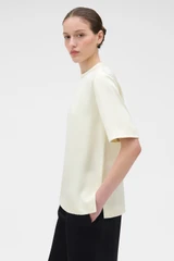 Profile view of model wearing the Oroton Double Satin Tee in Champagne and 100% viscose fabric for Women .