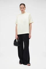 Profile view of model wearing the Oroton Double Satin Tee in Champagne and 100% viscose fabric for Women .