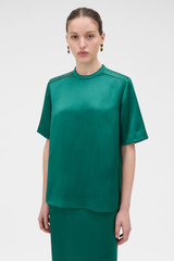 Profile view of model wearing the Oroton Double Satin Tee in Neptune Green and 100% viscose fabric for Women .