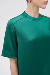 Profile view of model wearing the Oroton Double Satin Tee in Neptune Green and 100% viscose fabric for Women .
