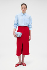 Profile view of model wearing the Oroton Silk Long Sleeve Shirt in Cloud Blue and 100% silk dupion fabric for Women .