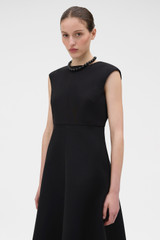 Profile view of model wearing the Oroton Structured Dress in Black and 100% cotton fabric for Women .