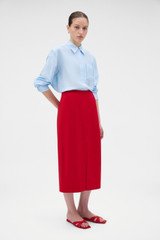 Profile view of model wearing the Oroton Crepe Split Front Skirt in Rich Red and 96% viscose and 4% spandex blend fabric for Women .