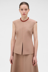 Profile view of model wearing the Oroton Structured Top in Burnt Rose and 100% cotton fabric for Women .