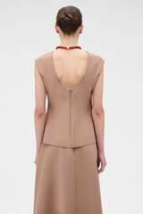 Profile view of model wearing the Oroton Structured Top in Burnt Rose and 100% cotton fabric for Women .