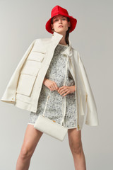 Profile view of model wearing the Oroton Utility Parka in White and 100% cotton fabric for Women .