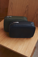 Profile view of model wearing the Oroton Oscar Pebble Tech Case in Black and Premium pebble leather for Men .