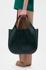 Profile view of model wearing the Oroton Emilia Crackle Large Tote in Shade Green and Premium crackle leather for Women .